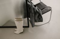 Kaboompics - Black Leather Jacket and White Knee-High Boot in Minimal Interior