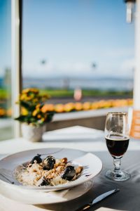 Kaboompics - Vertical Seafood Risotto with Mussels and Red Wine at a Seaside Restaurant Window