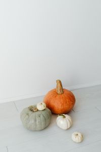 Kaboompics - Three Pumpkins on a White Floor