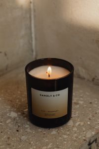 Kaboompics - Close-Up of Lit Candle Label on Concrete