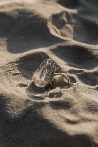 Kaboompics - Minimal Silver Ring on Sunlit Beach Sand with Copy Space