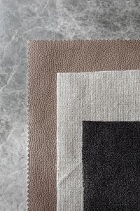 Kaboompics - Layered Taupe, White, and Black Bouclé Upholstery Fabric Samples