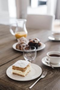 Sweet dessert with cream and a cup of coffee on a table