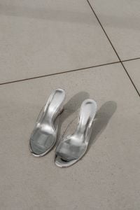 Kaboompics - Silver Heeled Mules on a Beige Stone Floor