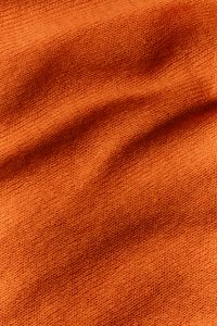 Kaboompics - Burnt Orange Knit Close-Up – Soft Sweater Fabric Folds