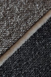 Kaboompics - Layered Black and Gray Bouclé Upholstery Fabric Swatches
