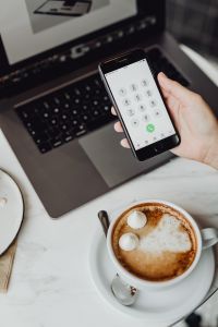 Kaboompics - Working with a laptop & iPhone X, meringue with whipped cream and coffee on white marble