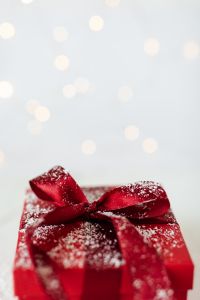 Kaboompics - Red Christmas Gift Box with Glitter Bow and Warm Bokeh Lights