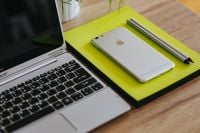 Kaboompics - Silver Acer Laptop And White Apple iPhone On Bright Yellow Notebook