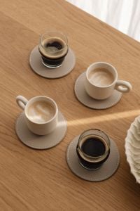 Kaboompics - Overhead Small Coffee Cups on a Wooden Table with Neutral Linen