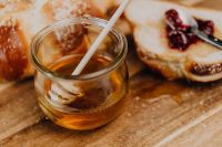 Kaboompics - Honey Jar With Dipper and Challah Toast on Wooden Board