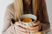 Kaboompics - Woman Holding a Mug of Orange Tea