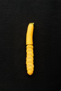 Kaboompics - Yellow Zucchini Slices on a Black Background