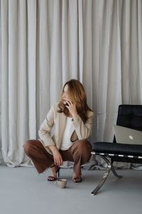 Kaboompics - Woman Talking on Her Phone while Holding a Cup
