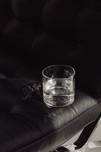 Kaboompics - Close-Up Tumbler on Quilted Black Leather Upholstery
