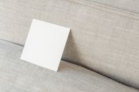 Kaboompics - Square Blank Card Mockup Propped on a Neutral Linen Couch