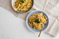 Kaboompics - Overhead Italian Carbonara in Two Blue Bowls on Marble
