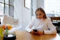 Kaboompics - Blonde Woman Taking a Break With Smartphone at Cafe