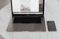 Kaboompics - MacBook Pro 15 laptop and iPhone 11 Pro on a marble table