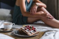Kaboompics - Woman Relaxing in Bed with a Coffee Cup and Raspberry Waffles