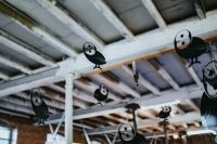 Kaboompics - Little black plastic owls hanging from a ceiling