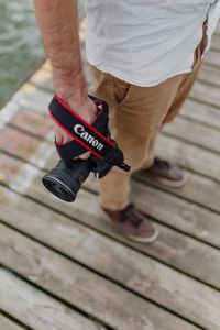Kaboompics - Photographer holding a DSLR camera