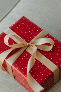 Kaboompics - Champagne Satin Bow on Red Valentine's Gift Wrap, Close Up