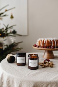 Kaboompics - Two Candle Jars beside Christmas Cake and Tree