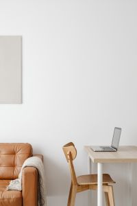 Kaboompics - Laptop and Open Planner Beside a Leather Sofa, Remote Work Lifestyle Scene