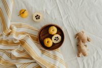 Kaboompics - Horizontal Japanese Quince Flat Lay with Ginger Root, Cut Fruit and Linen Copy Space