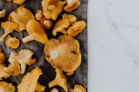 Kaboompics - Chanterelle Mushrooms On Black Cloth And Marble