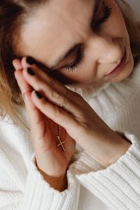 Kaboompics - Close-Up of Woman Resting Her Cheek on Praying Hands