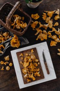 Kaboompics - Chanterelle Mushrooms, Basket And Knife On Wooden Table