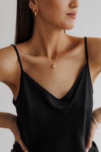 Kaboompics - Black Satin Camisole and Gold Pendant Jewelry Close-Up