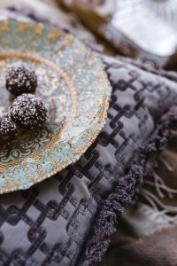 Kaboompics - Pomegranate Tarts and Coconut-Covered Truffles on an Ornate Blue Plate
