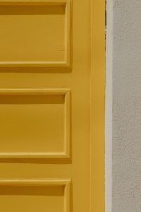 Kaboompics - Close-Up Mustard Yellow Door Panel and White Stucco Texture