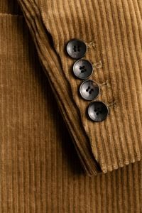 Kaboompics - Angled Camel Corduroy Blazer Sleeve with Dark Buttons, Ribbed Tailoring Detail