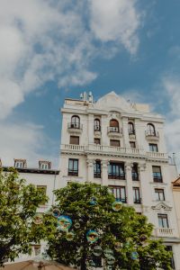Kaboompics - Madrid Street Scene with Soap Bubbles Rising Before an Ornate White Facade