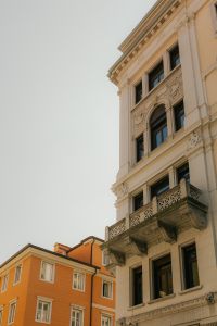 Kaboompics - Sunlit Old Town Street Between Terracotta Apartment Buildings