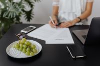 Kaboompics - Signing Contract Beside Grapes, Phone and Laptop