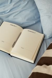 Kaboompics - Open Planner on Soft Blue Bedding
