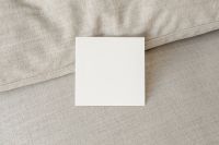 Kaboompics - Upright Blank Square Card Mockup Against a Sofa Back