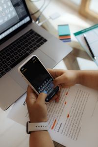 Kaboompics - Hands Typing on Smartphone at Work Desk