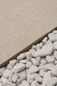 Kaboompics - Beige Stone Slab Bordering White Pebbles, Neutral Interior Background