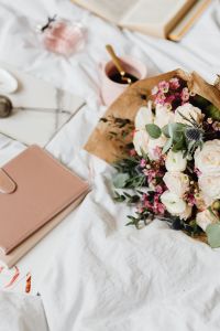 Kaboompics - Bouquet Beside a Book and Coffee Cup in Bed
