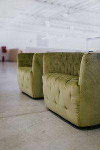 Kaboompics - Row of Olive Green Tufted Armchairs in a Bright Furniture Exhibition
