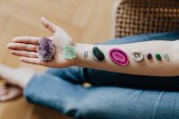Kaboompics - Amethyst, Green Stones and Agate Arranged along an Arm and Open Palm, Crystal Healing