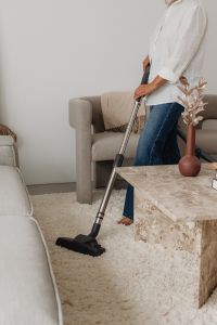 Kaboompics - Woman Vacuuming a Living Room Rug