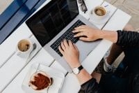 Kaboompics - Laptop and Espresso on a White Table by the Marina