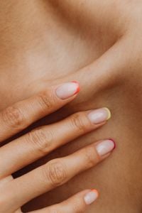 Kaboompics - Macro Beauty Crop of a Fingertip Pressing Bare Skin, Warm Close-Up of Shoulder Texture